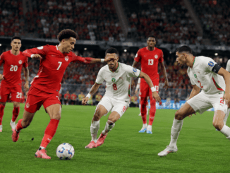 Canada and Morocco players compete for possession during the first half of the FIFA World Cup 2026 Round of 16 match at NRG Stadium.